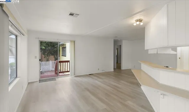 a view of a room with an empty room and a window