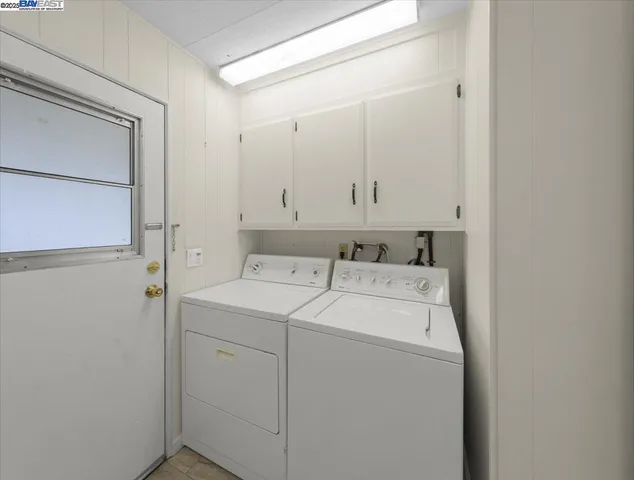 a view of an empty room with closet and a window