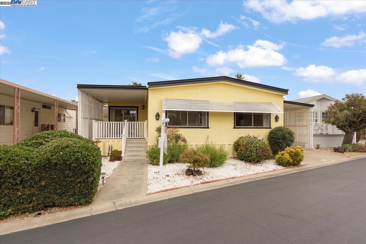 3263 Vineyard Avenue, Unit 44 Pleasanton, CA 94566 - Photo 2 of 31 a front view of a house with a yard