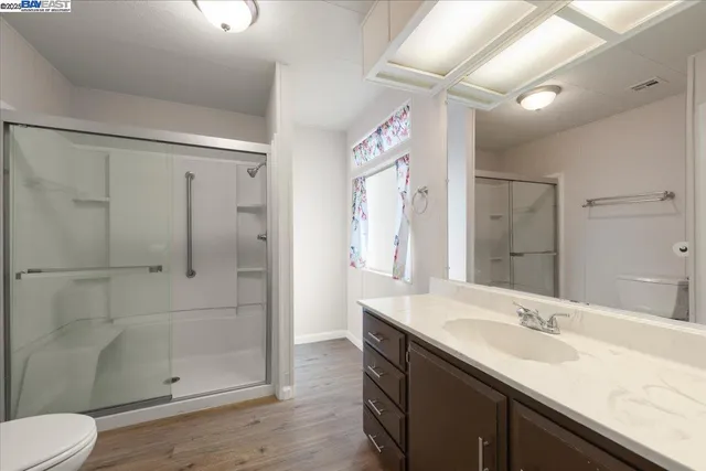 a view of an empty room with window and closet area