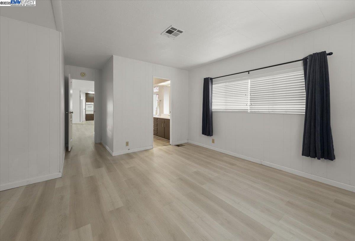 3263 Vineyard Avenue, Unit 44 Pleasanton, CA 94566 - Photo 22 of 31 a view of an empty room with window and closet area