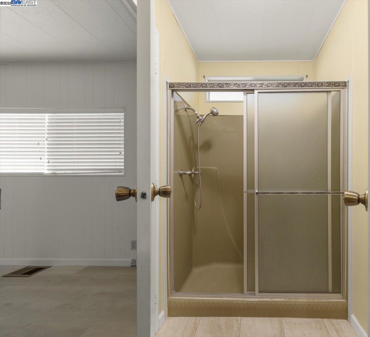 3263 Vineyard Avenue, Unit 44 Pleasanton, CA 94566 - Photo 29 of 31 a bathroom with a glass shower door