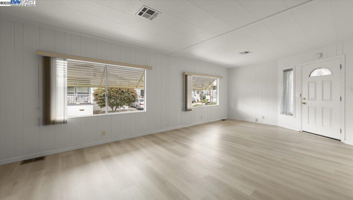 3263 Vineyard Avenue, Unit 44 Pleasanton, CA 94566 - Photo 7 of 31 an empty room with wooden floor and windows