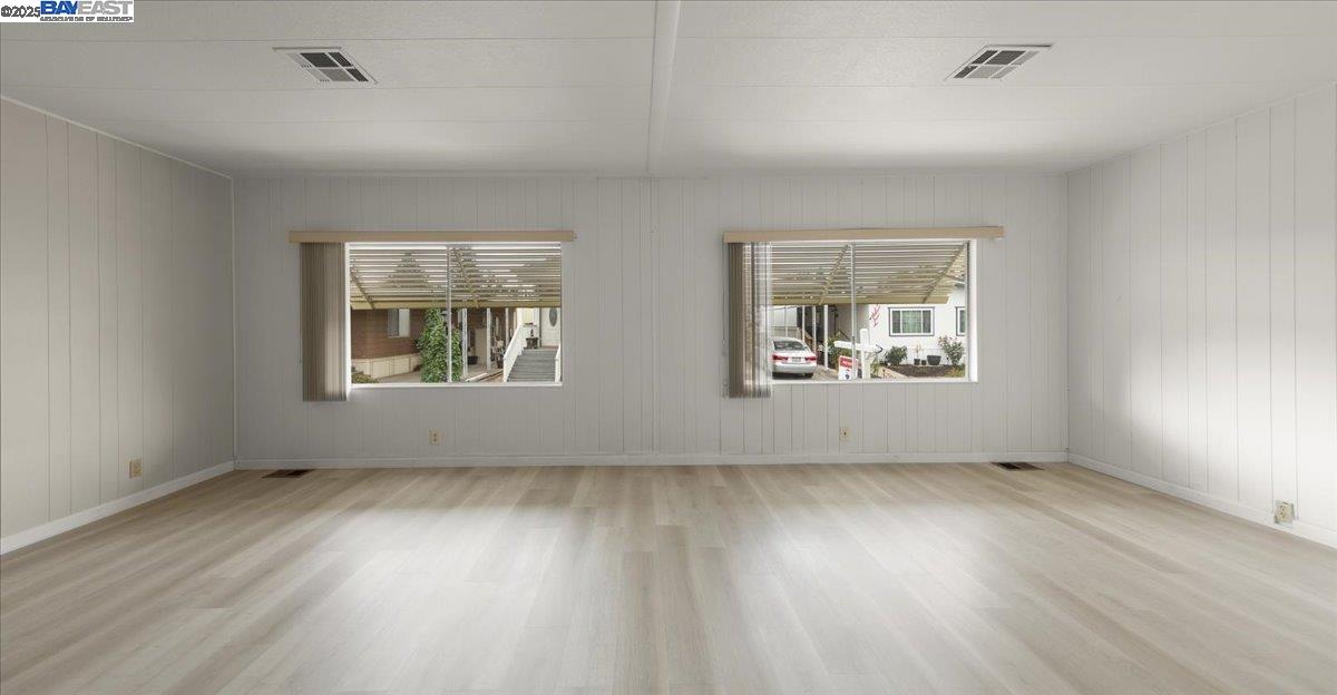3263 Vineyard Avenue, Unit 44 Pleasanton, CA 94566 - Photo 8 of 31 a view of an empty room with wooden floor and a window