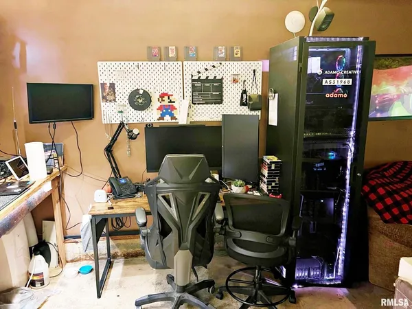 a view of a workspace with furniture and a flat screen tv