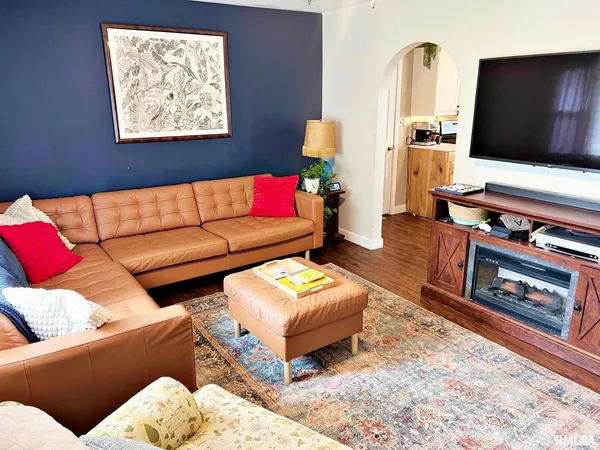 a living room with furniture and a flat screen tv