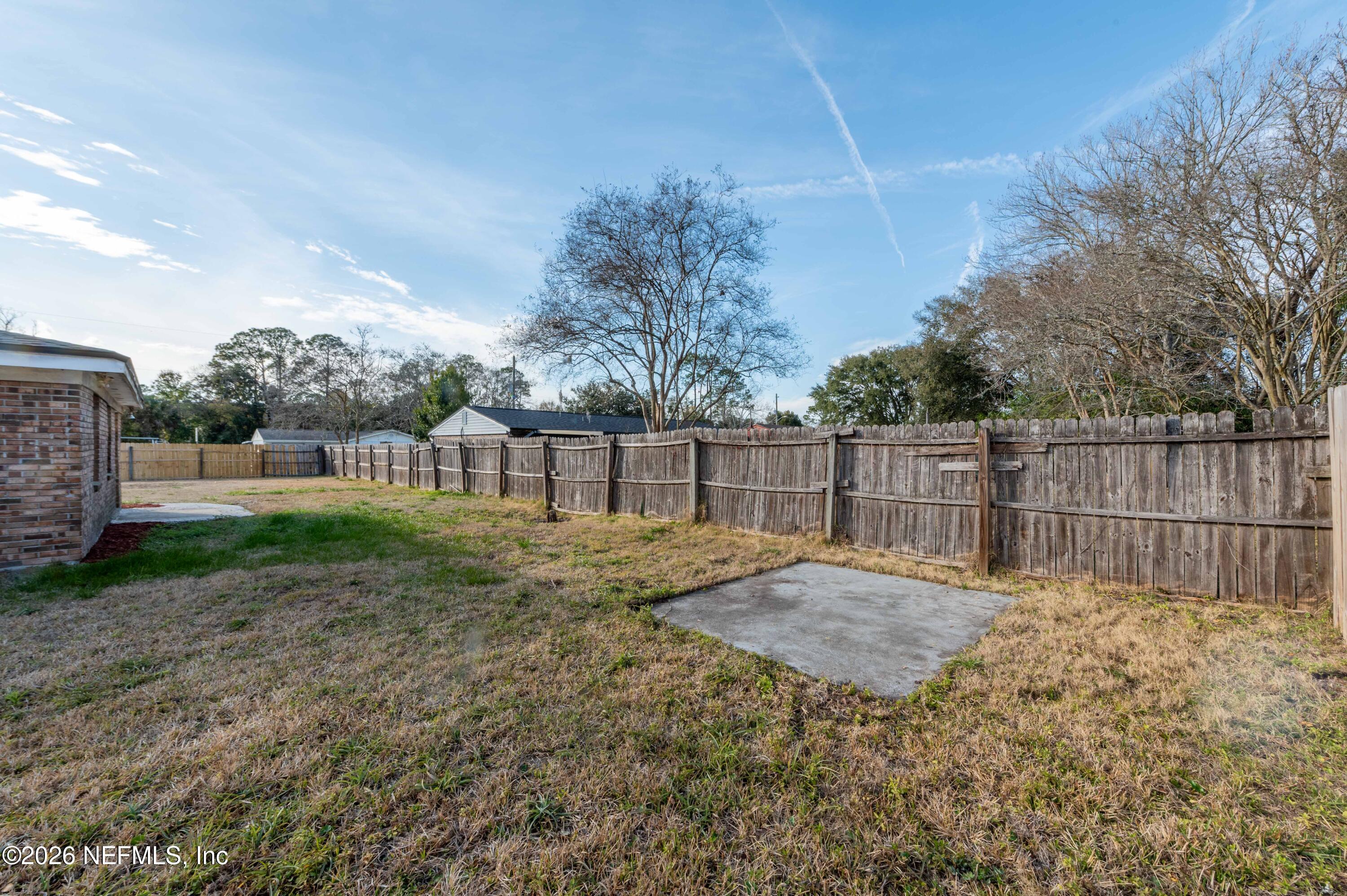 11605 Bayou Road Jacksonville, FL 32246 - Photo 13 of 39 a backyard of a house with lots of green space