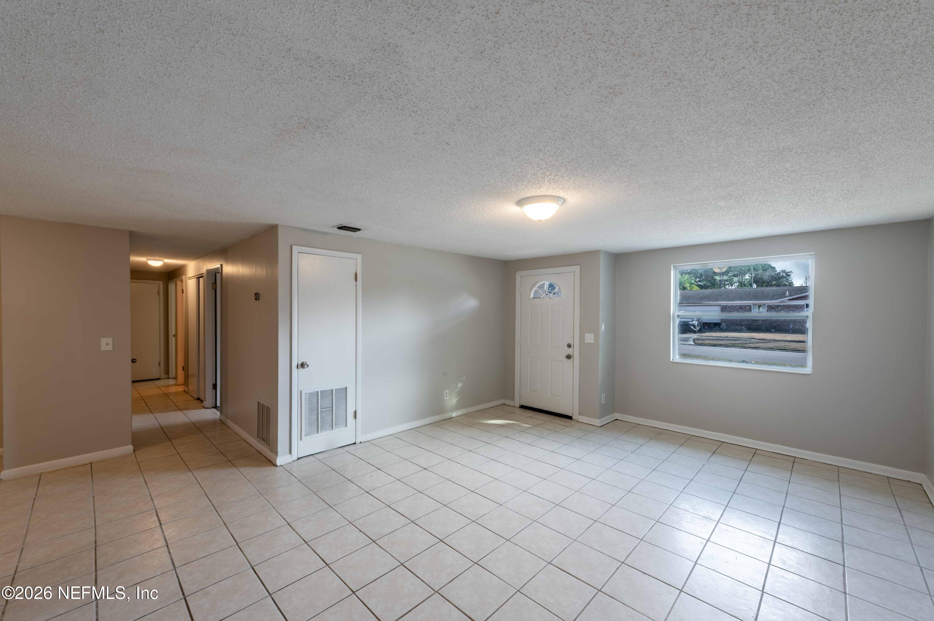 11605 Bayou Road Jacksonville, FL 32246 - Photo 17 of 39 a view of an empty room and window