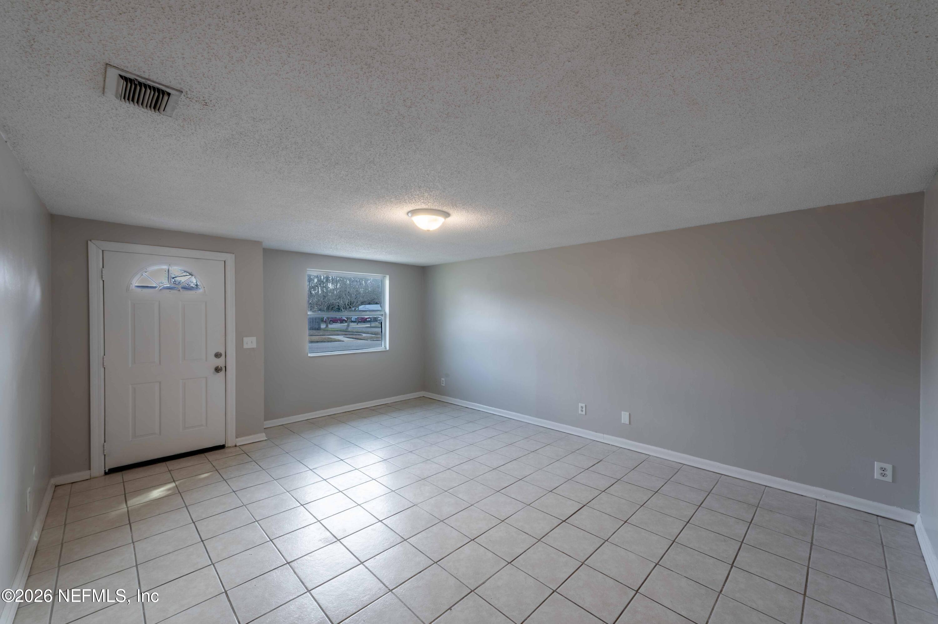 11605 Bayou Road Jacksonville, FL 32246 - Photo 18 of 39 a view of an empty room and window