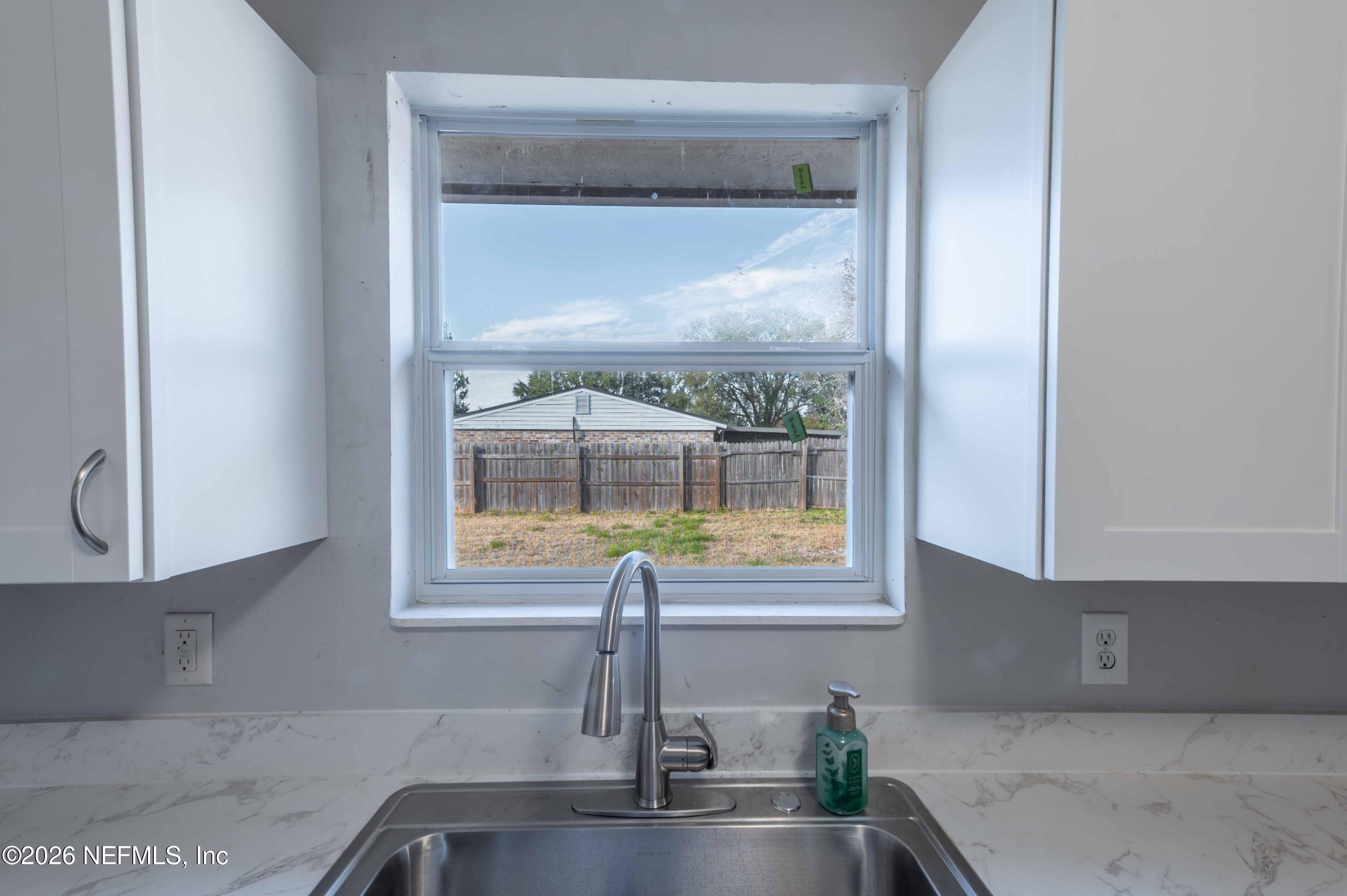 11605 Bayou Road Jacksonville, FL 32246 - Photo 25 of 39 a kitchen with a sink and a window