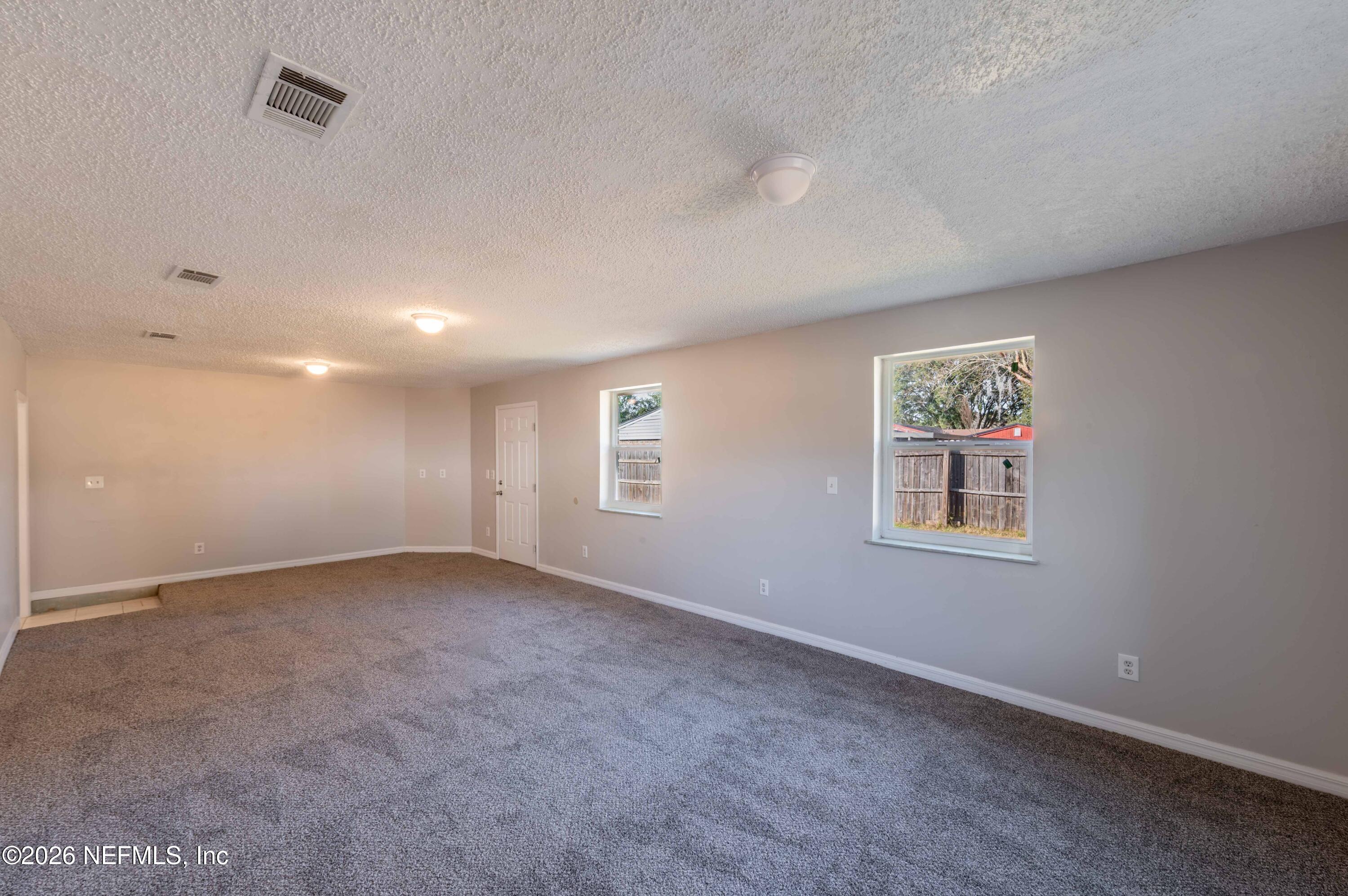 11605 Bayou Road Jacksonville, FL 32246 - Photo 29 of 39 a view of an empty room with a window