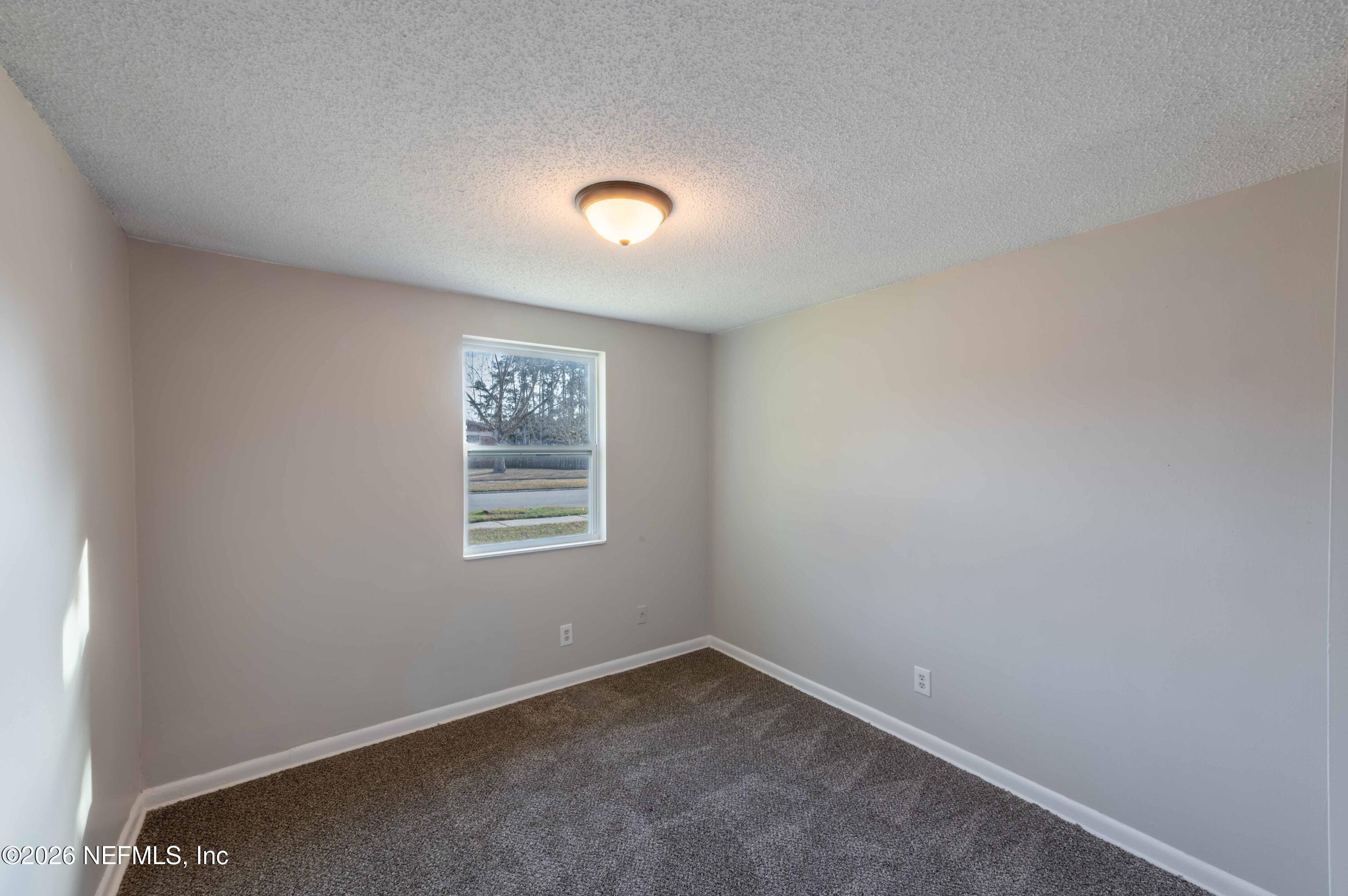 11605 Bayou Road Jacksonville, FL 32246 - Photo 30 of 39 an empty room with a window