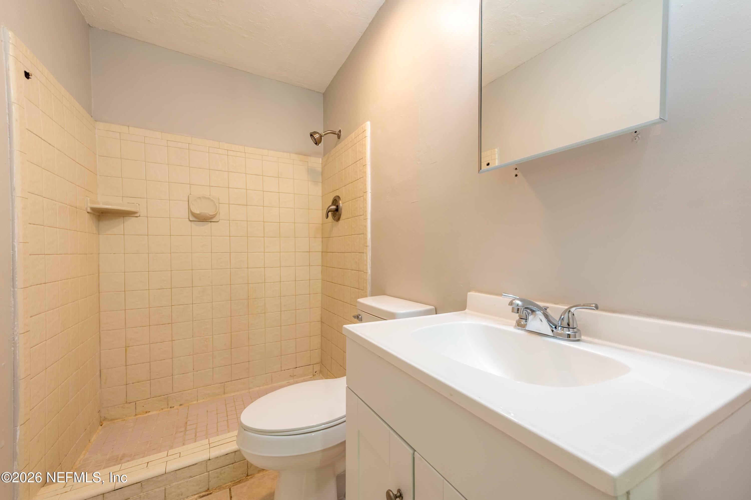11605 Bayou Road Jacksonville, FL 32246 - Photo 3 of 39 a bathroom with a sink toilet and shower