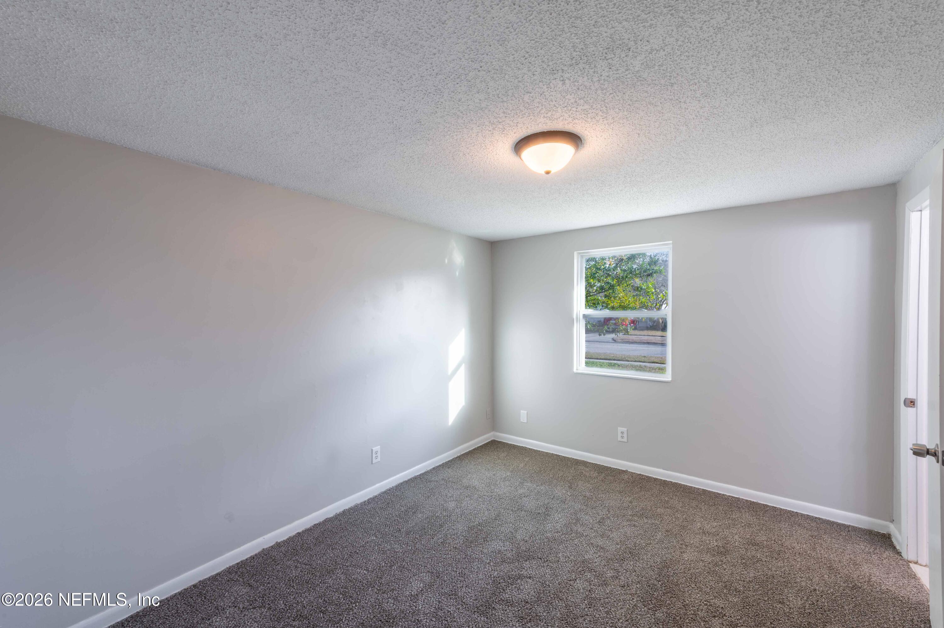 11605 Bayou Road Jacksonville, FL 32246 - Photo 33 of 39 an empty room with a window