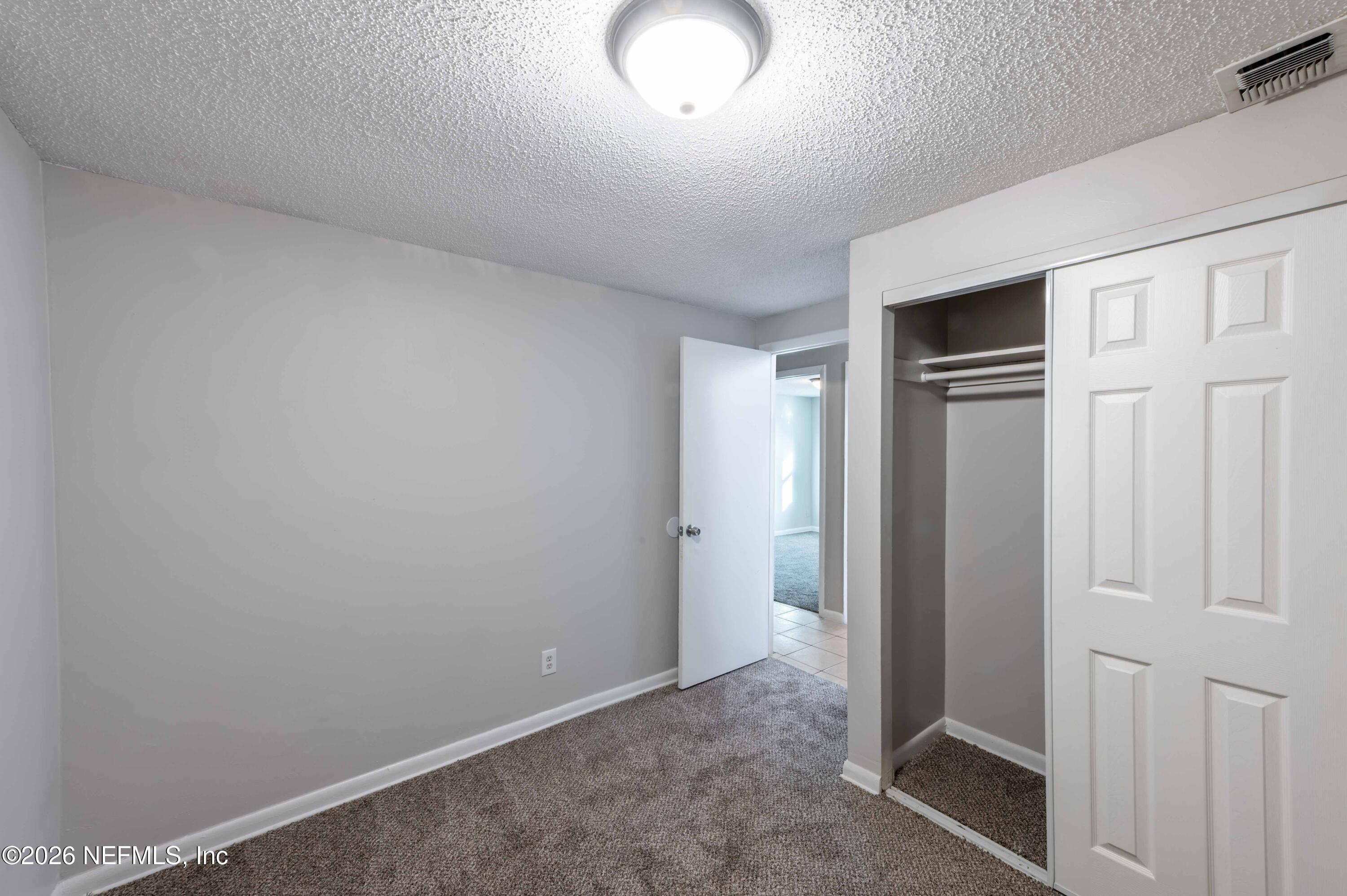 11605 Bayou Road Jacksonville, FL 32246 - Photo 39 of 39 an empty room with closet area