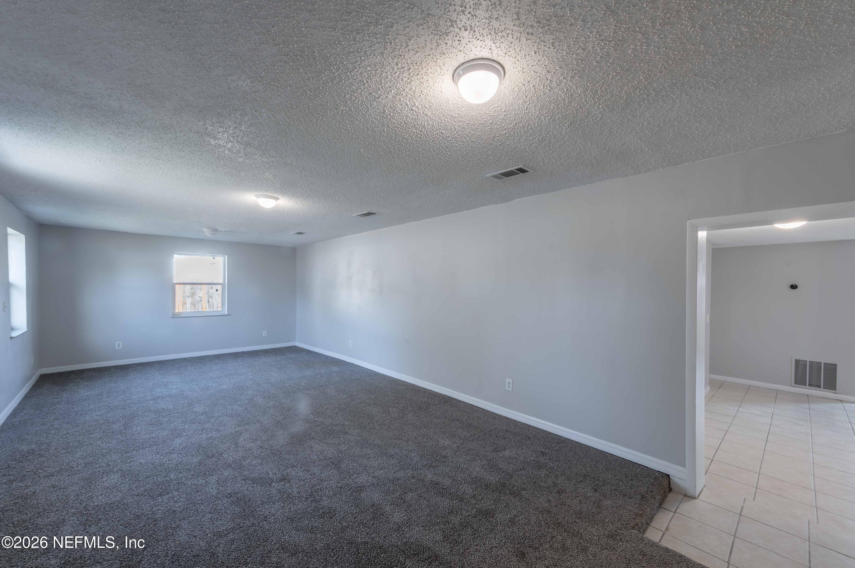 11605 Bayou Road Jacksonville, FL 32246 - Photo 5 of 39 an empty room with a empty space and windows