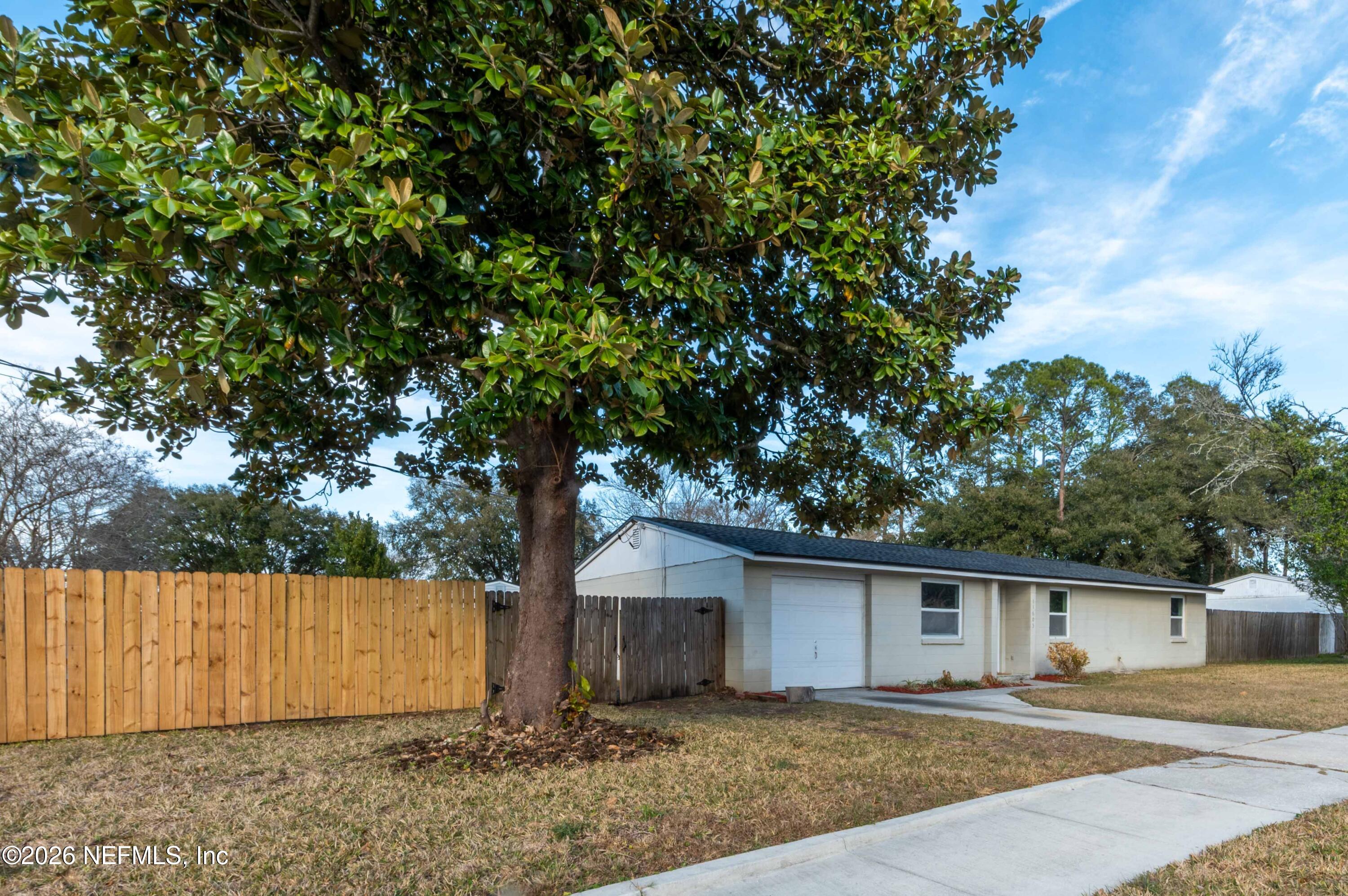 11605 Bayou Road Jacksonville, FL 32246 - Photo 8 of 39 a house with a tree in front of it