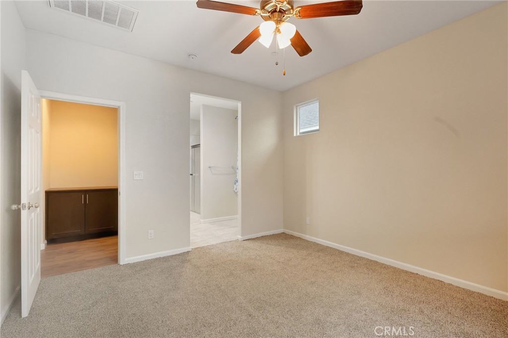 511 Glendon Court Merced, CA 95348 - Photo 13 of 37 an empty room with closet and a chandelier fan