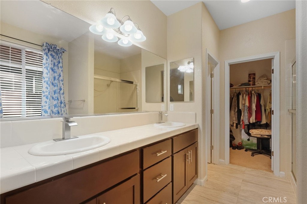 511 Glendon Court Merced, CA 95348 - Photo 20 of 37 a bathroom with a sink double vanity and a mirror