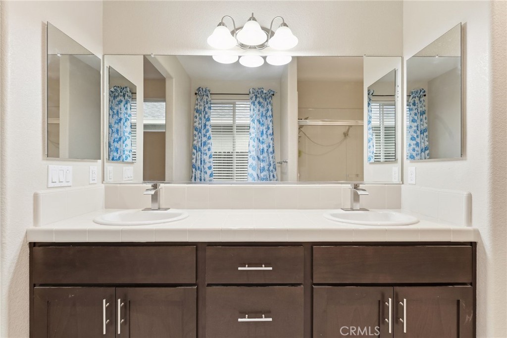 511 Glendon Court Merced, CA 95348 - Photo 23 of 37 a bathroom with a sink vanity and a mirror