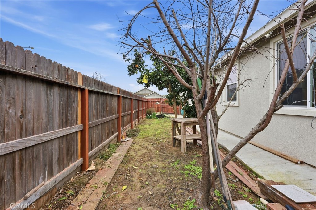 511 Glendon Court Merced, CA 95348 - Photo 31 of 37 a view of backyard with wooden fence and large trees