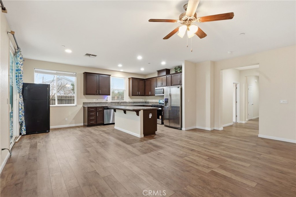 511 Glendon Court Merced, CA 95348 - Photo 7 of 37 a kitchen with stainless steel appliances kitchen island a refrigerator and a microwave