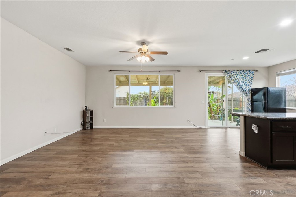 511 Glendon Court Merced, CA 95348 - Photo 9 of 37 wooden floor in an empty room with a window