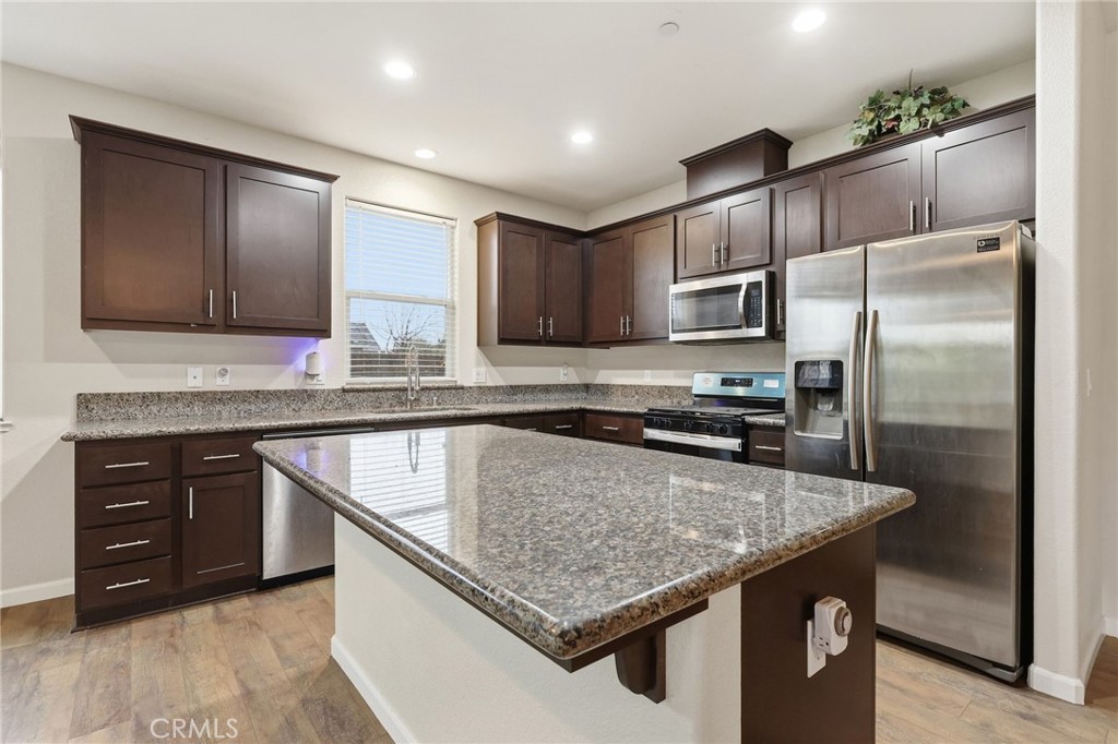 511 Glendon Court Merced, CA 95348 - Photo 10 of 37 a kitchen with stainless steel appliances granite countertop a sink stove and refrigerator