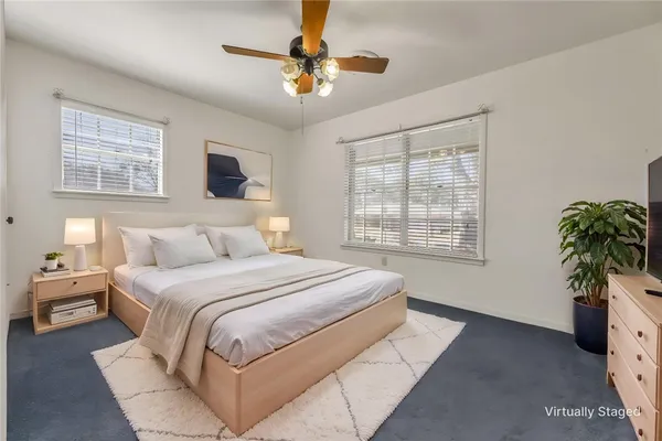 a bedroom with a large bed and a window