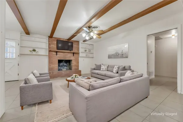 a living room with furniture and a fireplace