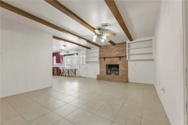 wooden floor in an empty room with a fireplace