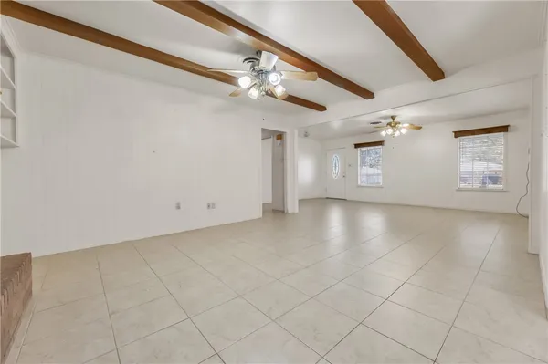 a view of a livingroom with a ceiling fan and window
