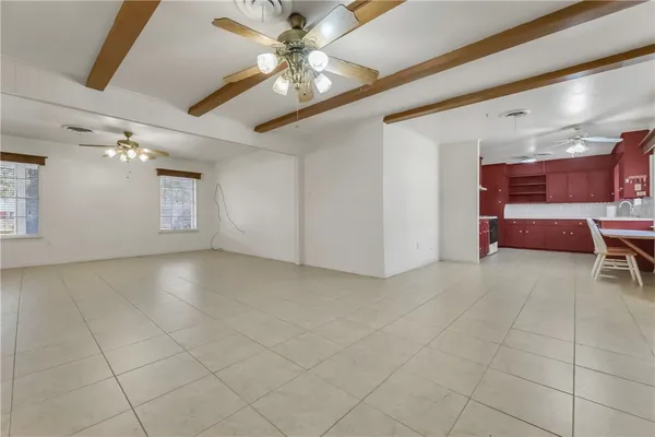 a view of a livingroom with furniture and chandelier fan