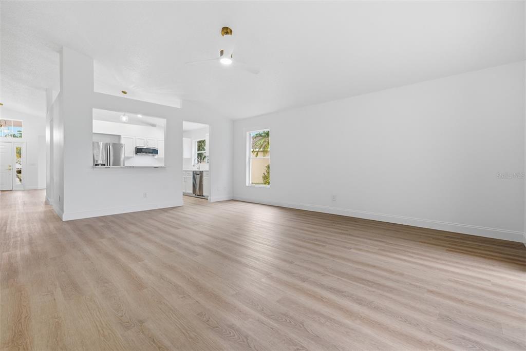 4534 Cabbage Key Terrace Bradenton, FL 34203 - Photo 12 of 33 an empty room with wooden floor and windows