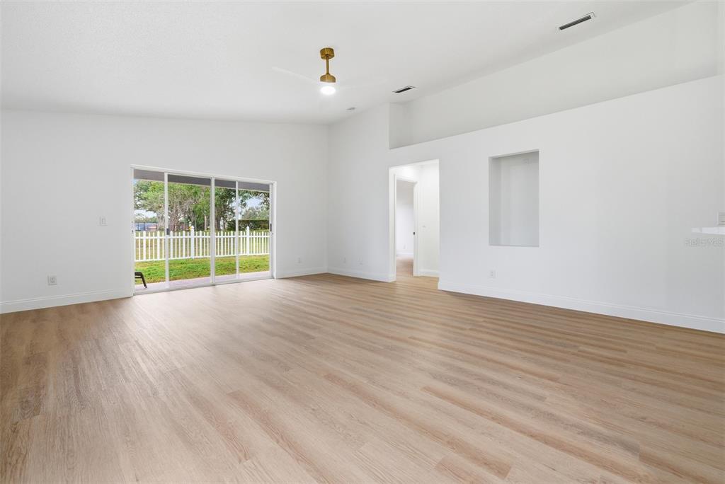 4534 Cabbage Key Terrace Bradenton, FL 34203 - Photo 13 of 33 an empty room with wooden floor and windows