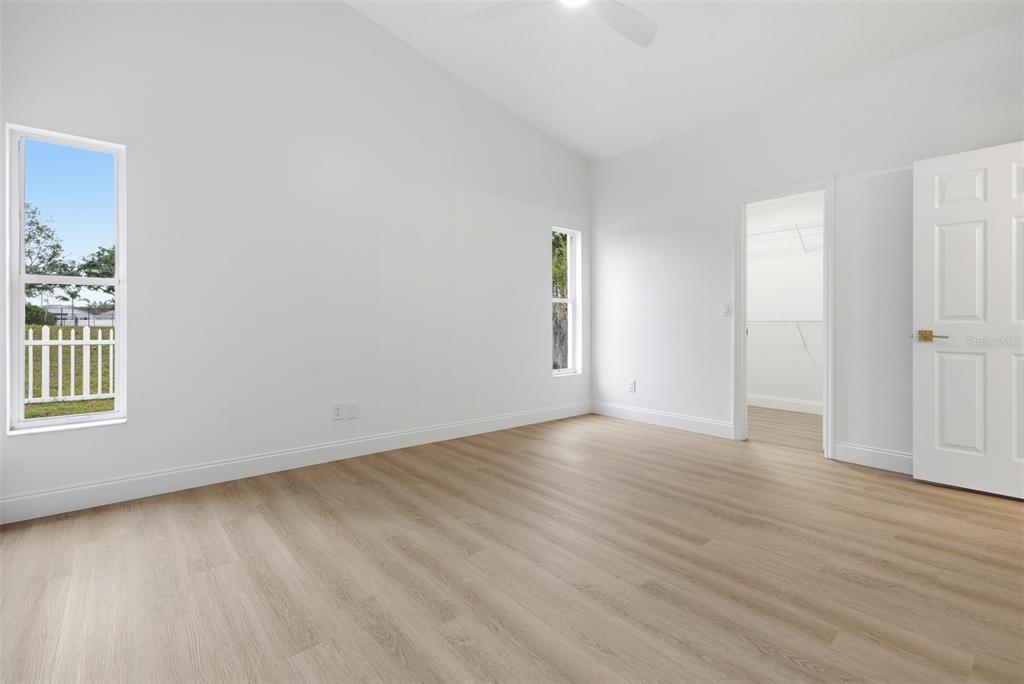 4534 Cabbage Key Terrace Bradenton, FL 34203 - Photo 16 of 33 an empty room with wooden floor and windows