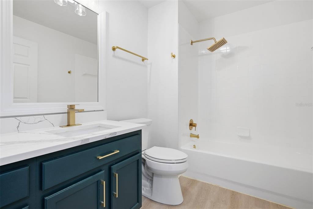 4534 Cabbage Key Terrace Bradenton, FL 34203 - Photo 22 of 33 a bathroom with a granite countertop sink a toilet and shower