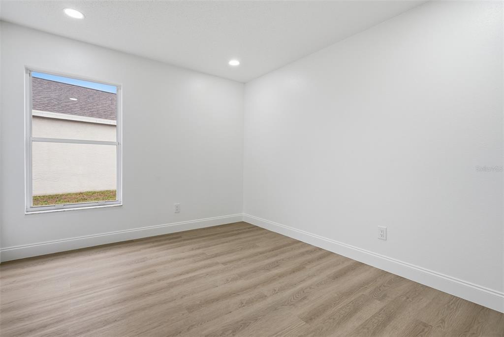 4534 Cabbage Key Terrace Bradenton, FL 34203 - Photo 23 of 33 a view of an empty room with wooden floor and a window