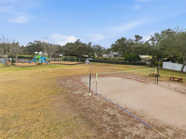 a view of swimming pool with outdoor seating and yard in back