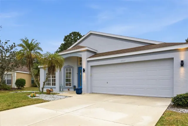 a view of a house with a yard and garage