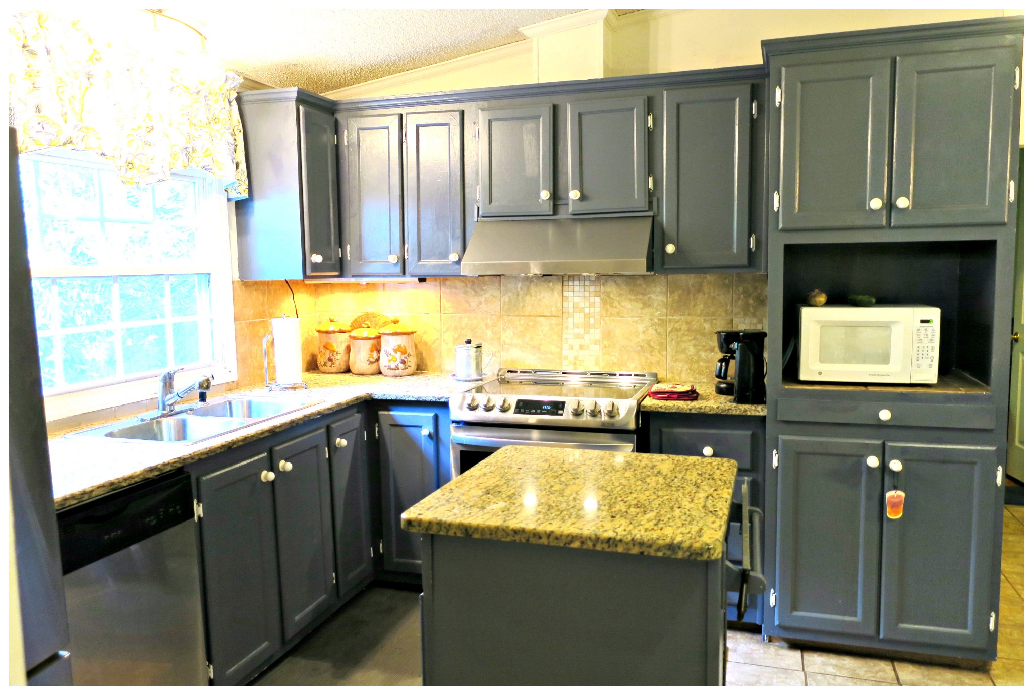 605 Thompson Road Pegram, TN 37143 - Photo 4 of 28 a kitchen with kitchen island granite countertop a sink a counter top space and cabinets
