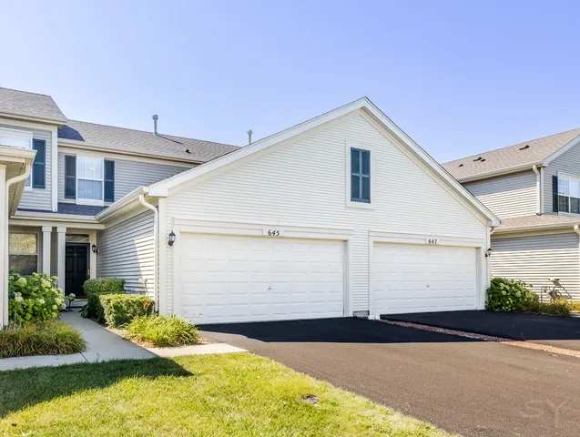 a view of backyard of house with yard and garage