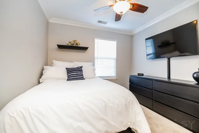 a bedroom with a bed and a flat screen tv
