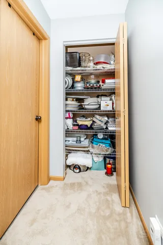 a room with storage and a fridge