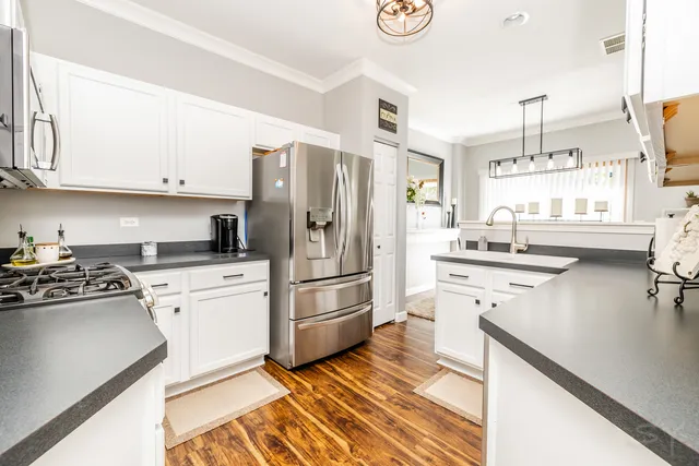 a kitchen with a refrigerator stove and sink