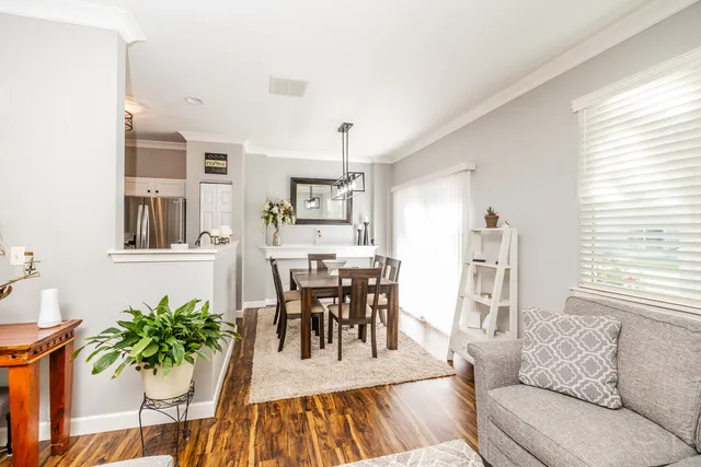 a living room with furniture dining room and wooden floor
