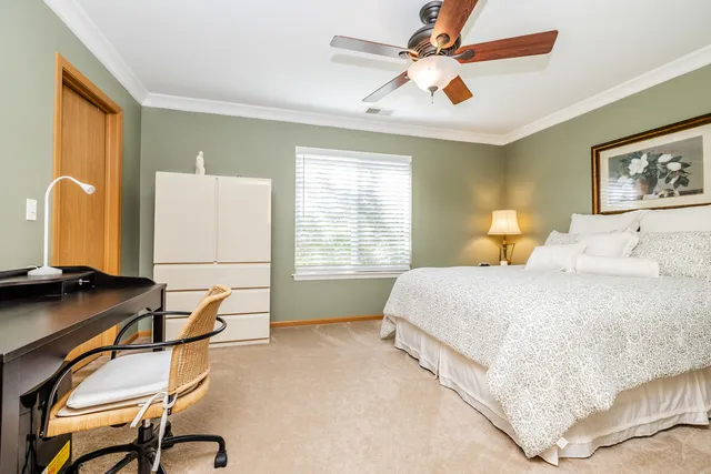 a bedroom with a bed and a desk