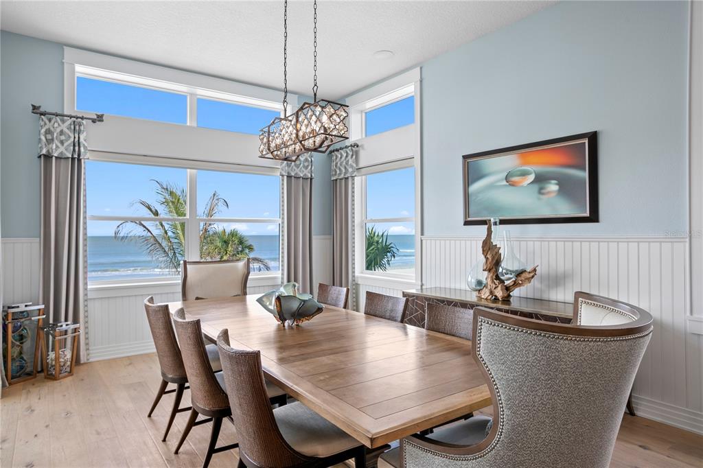 15612 Gulf Boulevard Redington Beach, FL 33708 - Photo 17 of 92 a view of a dining room with furniture wooden floor and chandelier