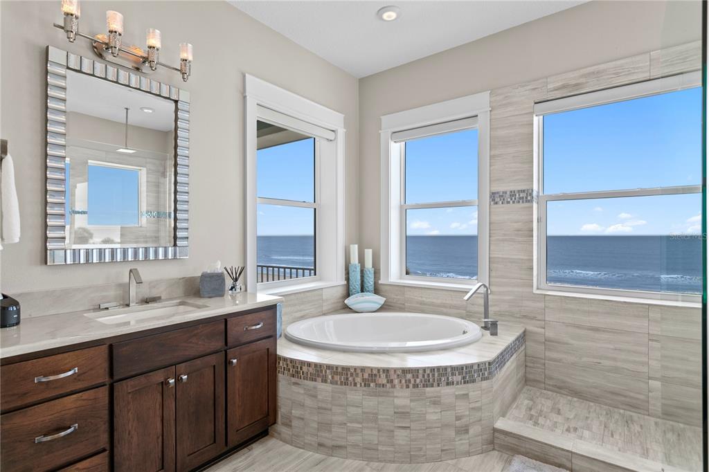 15612 Gulf Boulevard Redington Beach, FL 33708 - Photo 40 of 92 a bathroom with a tub sink and mirror