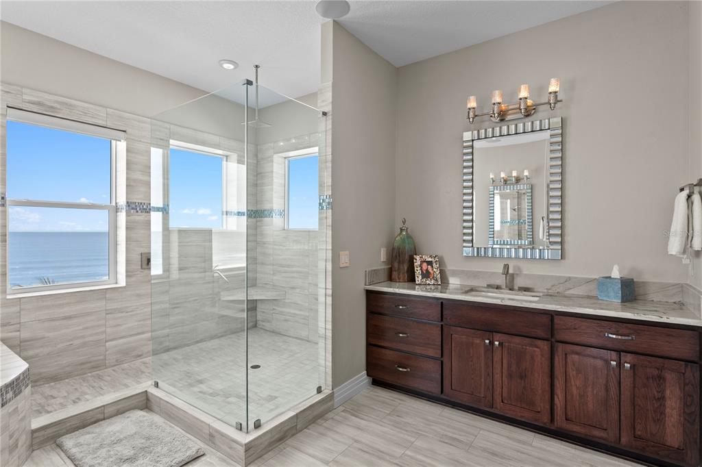 15612 Gulf Boulevard Redington Beach, FL 33708 - Photo 42 of 92 a bathroom with a double vanity sink mirror and shower